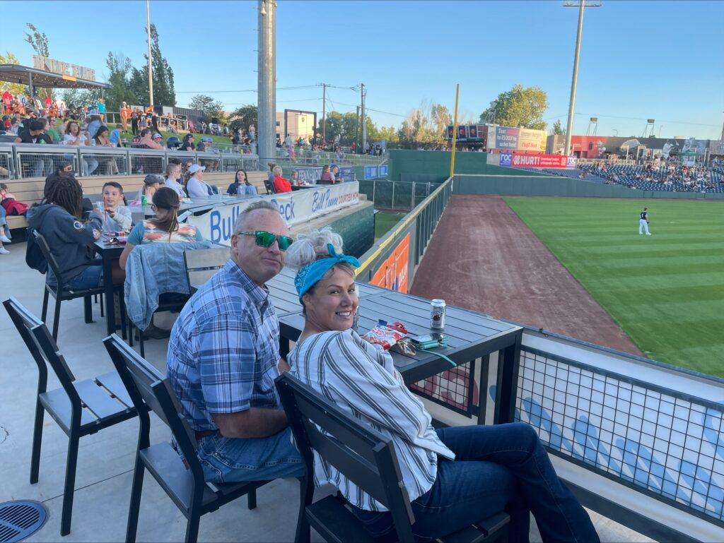 Inline image showing different members of the LP Insurance team bonding at a local baseball game. 