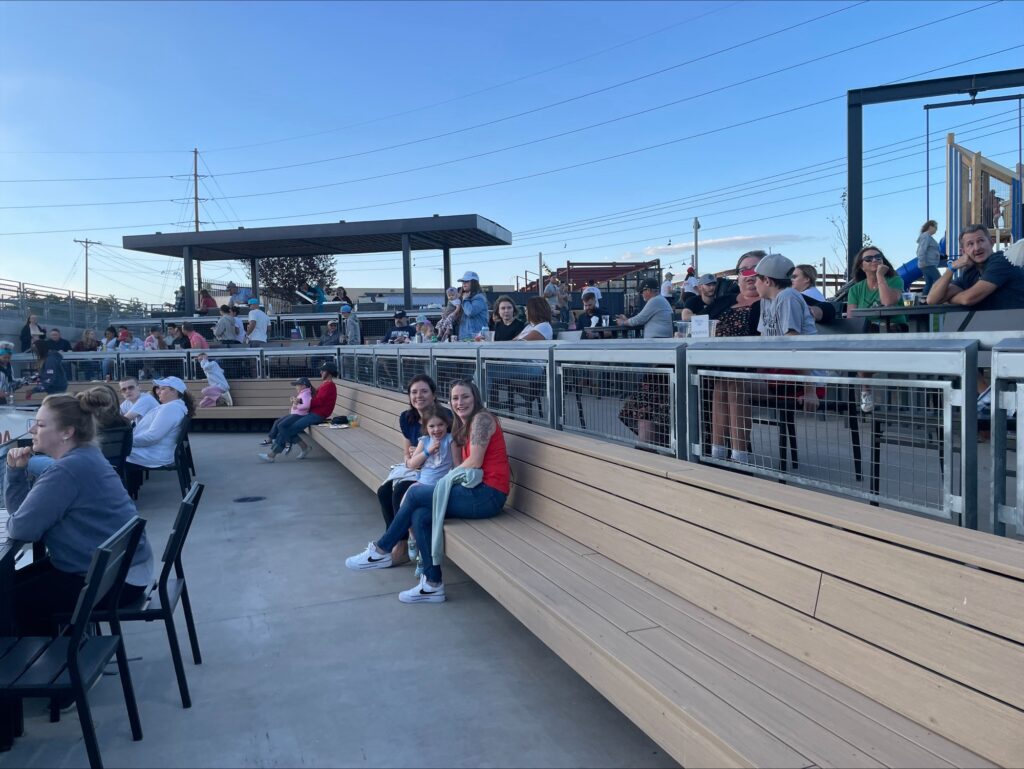 Inline image showing the LP Insurance team with their families at a local baseball game. 