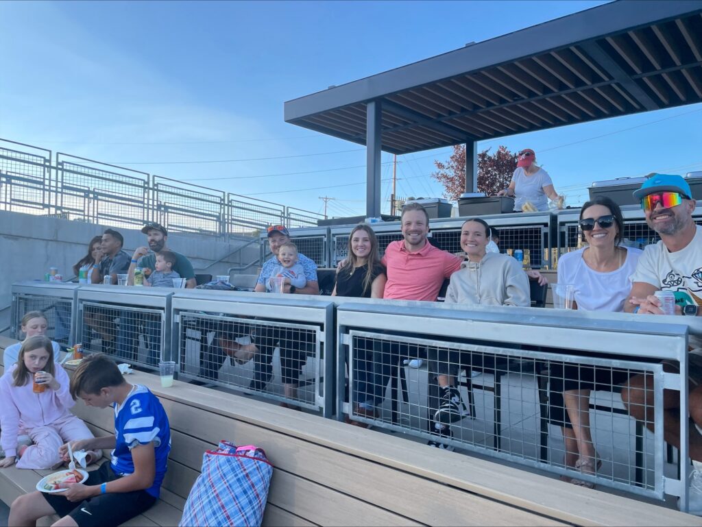 Inline image showing the LP Insurance team with their families bonding at a local baseball game. 