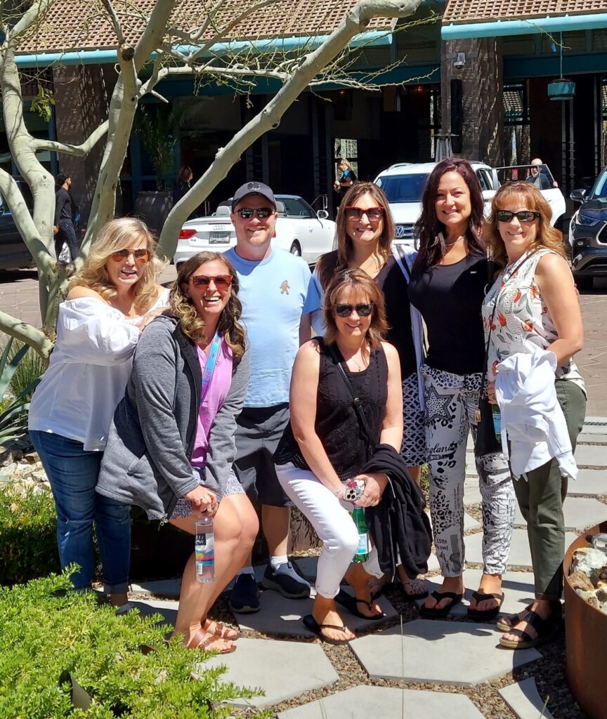 Featured image showing the LP Insurance Team on an afternoon outing posing together, by a tree wearing sunglasses.